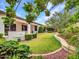 Lush backyard featuring a well-maintained lawn, mature trees, and decorative landscaping for serene outdoor living at 3809 E Lynx Pl, Chandler, AZ 85249