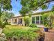Spacious backyard with lush green lawn, manicured landscaping, and a covered patio perfect for outdoor enjoyment at 3809 E Lynx Pl, Chandler, AZ 85249