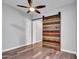 Bedroom with stylish barn door, hardwood floors, and neutral paint, creating a versatile space at 3809 E Lynx Pl, Chandler, AZ 85249