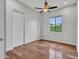 Bedroom features hardwood floors, a ceiling fan, and a closet for ample storage at 3809 E Lynx Pl, Chandler, AZ 85249