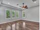 Bedroom featuring hardwood floors, a tray ceiling, multiple windows, and recessed lighting at 3809 E Lynx Pl, Chandler, AZ 85249