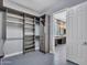 Spacious walk-in closet with custom shelving leading into a modern bathroom showcasing vanity and window at 3809 E Lynx Pl, Chandler, AZ 85249