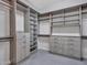A luxurious walk-in closet provides ample storage space with custom shelving and drawers in modern design at 3809 E Lynx Pl, Chandler, AZ 85249