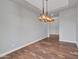 Formal dining room is brightly lit with hardwood floors and an elegant chandelier at 3809 E Lynx Pl, Chandler, AZ 85249