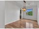 Formal dining room is brightly lit with hardwood floors and views out the window at 3809 E Lynx Pl, Chandler, AZ 85249