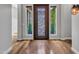 Elegant entryway features wood flooring, detailed front door with side windows, and modern lighting at 3809 E Lynx Pl, Chandler, AZ 85249