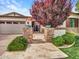 Inviting front entrance with brick pillars, stone walkway, and lush green landscaping at 3809 E Lynx Pl, Chandler, AZ 85249