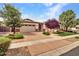 Charming single-story home featuring a stone accent facade, attached garage, and manicured landscaping at 3809 E Lynx Pl, Chandler, AZ 85249