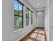 Bright hallway with hardwood floors and large windows overlooking the front yard at 3809 E Lynx Pl, Chandler, AZ 85249