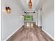 Hallway showcases wood floors, modern light fixtures, and a glimpse into an open living space at 3809 E Lynx Pl, Chandler, AZ 85249
