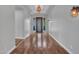 Hallway leading to an ornate front door, wood flooring and modern lighting throughout at 3809 E Lynx Pl, Chandler, AZ 85249