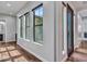 Inviting hallway with hardwood floors, black trimmed windows, and a decorative front door at 3809 E Lynx Pl, Chandler, AZ 85249