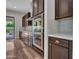 This kitchen features stainless steel appliances, hardwood floors, and stone countertops at 3809 E Lynx Pl, Chandler, AZ 85249