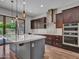 Well-lit kitchen featuring a large island, stainless steel appliances, and seamless access to the backyard at 3809 E Lynx Pl, Chandler, AZ 85249