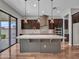 Gorgeous kitchen features an island, hardwood floors, stylish fixtures, and stainless appliances at 3809 E Lynx Pl, Chandler, AZ 85249