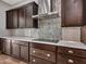 Elegant kitchen with custom backsplash, stainless steel range hood, and ample cabinet space at 3809 E Lynx Pl, Chandler, AZ 85249