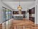 Spacious open-concept kitchen includes an island, stainless steel appliances and hardwood floors at 3809 E Lynx Pl, Chandler, AZ 85249