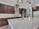 Modern kitchen boasts an island, stainless steel appliances, and custom cabinets for a chef-inspired culinary experience at 3809 E Lynx Pl, Chandler, AZ 85249