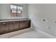 Bright laundry room features custom cabinets, counter space and hexagon tile flooring at 3809 E Lynx Pl, Chandler, AZ 85249