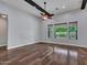 Open living space with large windows, hardwood floors, ceiling fan, and plenty of natural light at 3809 E Lynx Pl, Chandler, AZ 85249
