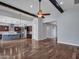 Spacious living room featuring hardwood floors, beam ceilings, and an open layout to the kitchen at 3809 E Lynx Pl, Chandler, AZ 85249