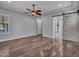 Large bedroom with hardwood floors, fan, barn door to bath, and window with view at 3809 E Lynx Pl, Chandler, AZ 85249