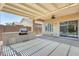 Covered back patio features a built-in BBQ area, ceiling fan, and view of the backyard at 38125 W Santa Clara Ave, Maricopa, AZ 85138