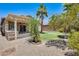 View of the shaded backyard including a covered patio and built-in grill at 38125 W Santa Clara Ave, Maricopa, AZ 85138