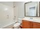 Bright bathroom featuring a vanity with mirror and a bathtub and shower combination at 38125 W Santa Clara Ave, Maricopa, AZ 85138