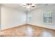 Spacious bedroom with tile flooring and two shuttered windows, letting in natural light at 38125 W Santa Clara Ave, Maricopa, AZ 85138