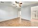 Large bedroom with tile flooring, a ceiling fan, and an en suite bathroom at 38125 W Santa Clara Ave, Maricopa, AZ 85138