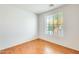 Bedroom with wood flooring and a window at 38125 W Santa Clara Ave, Maricopa, AZ 85138