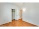 Bedroom with wood flooring featuring a closet and outdoor access at 38125 W Santa Clara Ave, Maricopa, AZ 85138