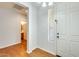 Bright entryway with tile floors and white walls with view of front door and a bathroom at 38125 W Santa Clara Ave, Maricopa, AZ 85138