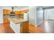 Kitchen boasts stainless appliances, wood cabinets, and large central island at 38125 W Santa Clara Ave, Maricopa, AZ 85138