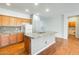 Kitchen features granite counters, wood cabinets, and stainless steel appliances at 38125 W Santa Clara Ave, Maricopa, AZ 85138