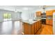Bright kitchen boasts a central island, wood cabinets, and stainless steel appliances at 38125 W Santa Clara Ave, Maricopa, AZ 85138