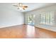 Open living room area with sliding glass doors and bright windows at 38125 W Santa Clara Ave, Maricopa, AZ 85138