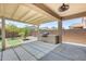 This patio features a built-in grill, covered area, and views of the backyard at 38125 W Santa Clara Ave, Maricopa, AZ 85138