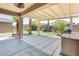 This patio features a built-in grill, covered area, and views of the green backyard at 38125 W Santa Clara Ave, Maricopa, AZ 85138