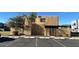 Beige condo with a small tree, short fence, and carport with parking in front of the unit at 5416 W Hearn Rd, Glendale, AZ 85306