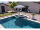 Private in-ground pool featuring lounge platform, in-pool umbrella, patio, and green backyard at 5919 S Newberry Rd, Tempe, AZ 85283