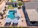 Aerial shot of a private in-ground pool and patio with blue and white umbrellas and lounge chairs at 5919 S Newberry Rd, Tempe, AZ 85283