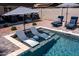 Beautiful in-ground pool with lounge chairs, patio, umbrellas, table, and chairs at 5919 S Newberry Rd, Tempe, AZ 85283