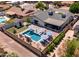 Aerial view of a backyard featuring a private in-ground pool, green yard, and covered patio at 5919 S Newberry Rd, Tempe, AZ 85283