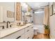 Dual sink bathroom vanity with modern fixtures, tiled shower, and decor at 5919 S Newberry Rd, Tempe, AZ 85283