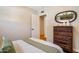 Bedroom with a wood dresser and a comfortable bed at 5919 S Newberry Rd, Tempe, AZ 85283