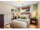 Cozy bedroom featuring a platform bed, wood floors, and a large window for natural light at 5919 S Newberry Rd, Tempe, AZ 85283