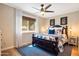 Bright bedroom with natural light, hardwood floors, and a ceiling fan at 5919 S Newberry Rd, Tempe, AZ 85283