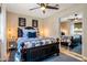 Bedroom with a ceiling fan, hardwood floors, and a wall mirror at 5919 S Newberry Rd, Tempe, AZ 85283